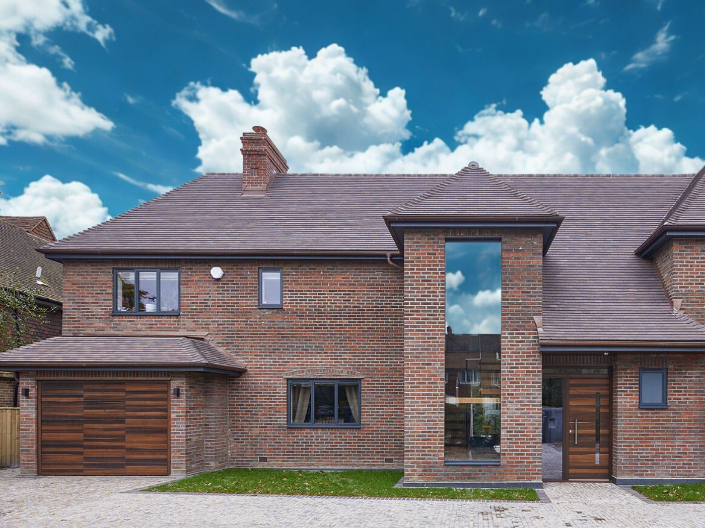 Matching front and garage doors creates a unified look within the brick finish