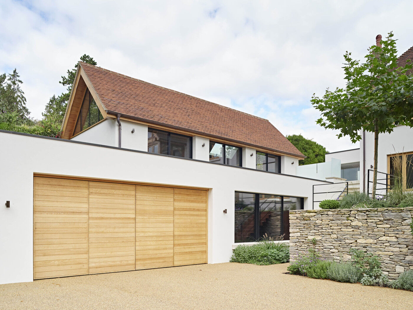 Our Parma design, double bifold garage door in European oak, measuring 5400mm W x 2400mm H