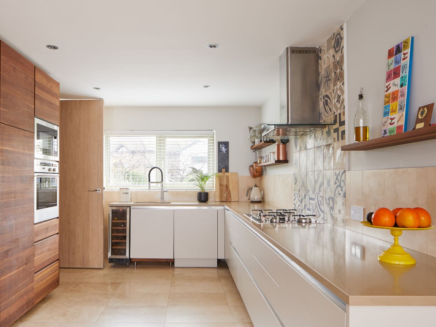 The wood of the internal door blends with the colours and woods in this kitchen
