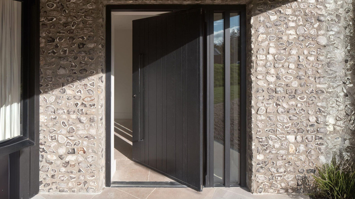 Pivot door in oak, finished with ebony oil and ridge sidelites