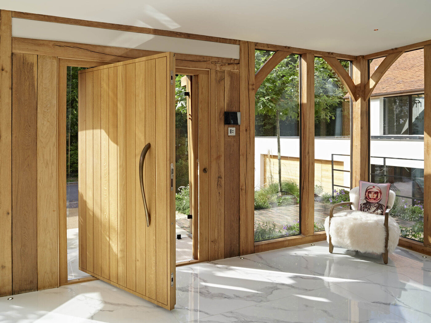 Our Porto design in European oak with a pivot opening (bronze handle on request). This door measures c. 1500mm W x 2100mm H.