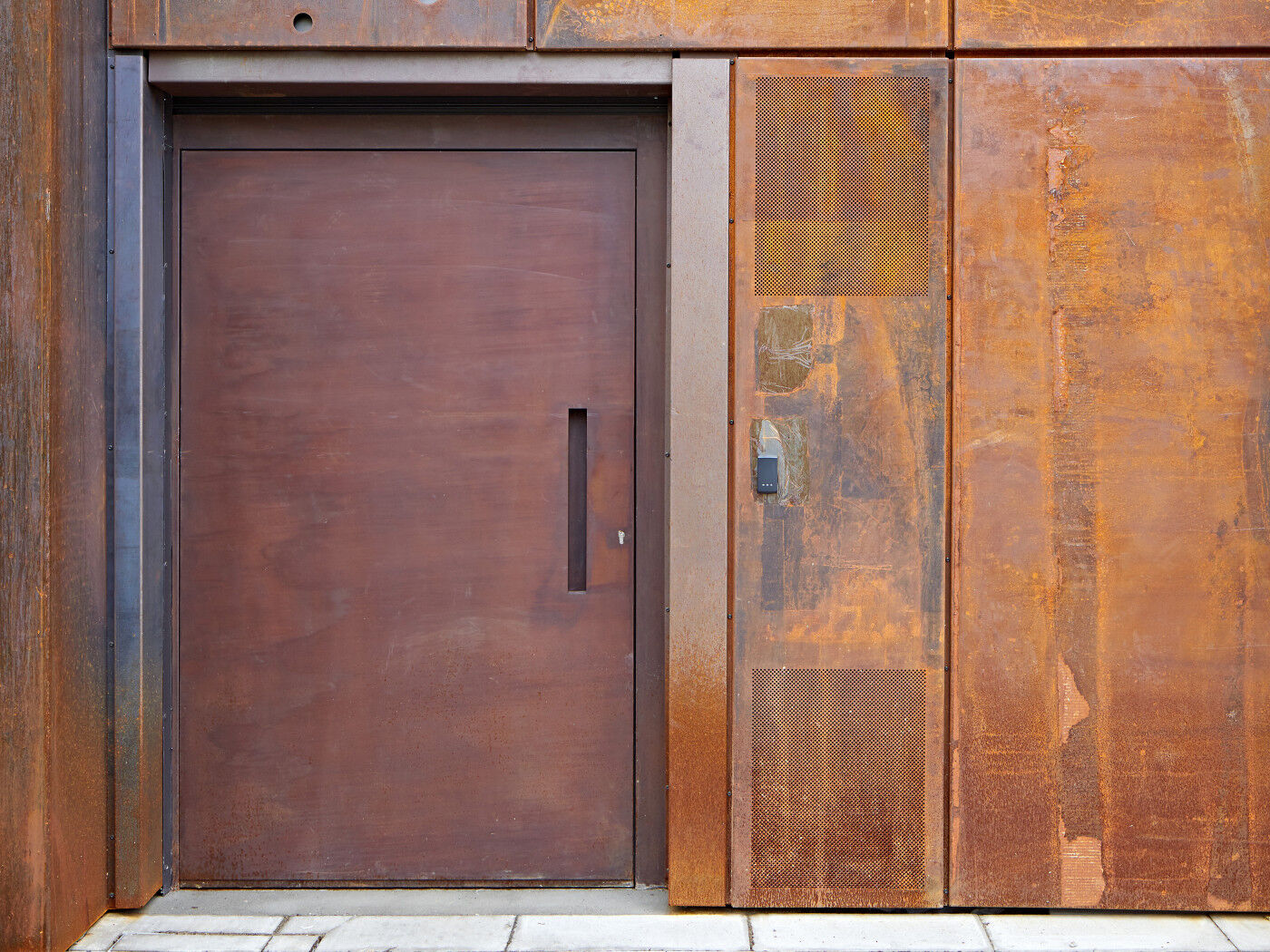"Raw" steel door in a rust (corten) finish on a commercial building in London