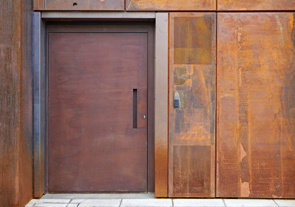 "Raw" steel door in a rust (corten) finish on a commercial building in London