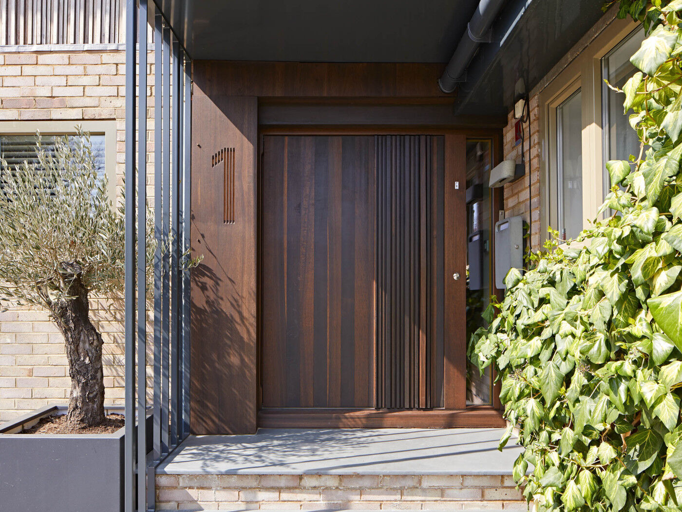 Bari door design in fumed oak, integrated wooden handle and number etching